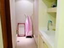 Compact hallway with laundry facilities and built-in cabinets