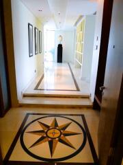 Elegant corridor inside a home with decorative flooring and modern art on the walls