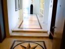 Elegant corridor inside a home with decorative flooring and modern art on the walls