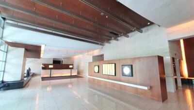 Spacious and modern lobby area with high ceiling and artistic decor