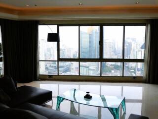 Spacious living room with large windows overlooking the city