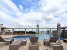 Rooftop swimming pool with lounge chairs and city skyline view