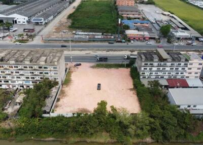 Aerial view of vacant lot with potential for development near urban area