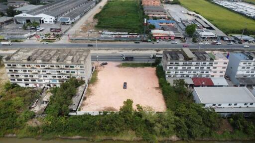 Aerial view of vacant lot with potential for development near urban area