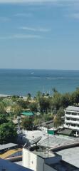 Coastal city view with ocean and trees from a high vantage point