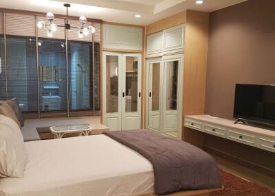 Modern bedroom with decorative lighting and a television set