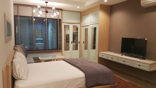 Modern bedroom with decorative lighting and a television set