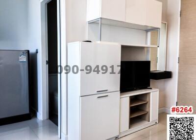 Compact modern kitchen with white cabinetry and built-in appliances