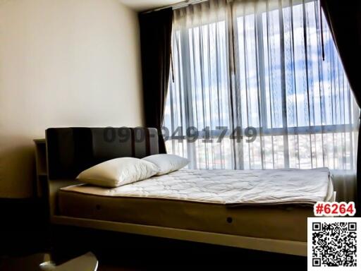 Modern bedroom with large window and sheer curtains