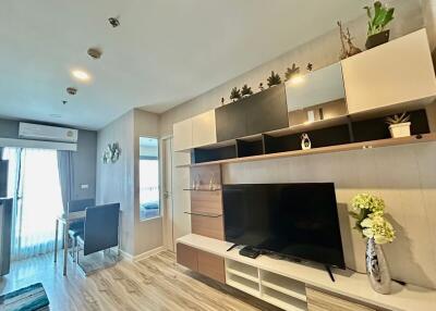 Modern living room with wide-screen TV and decorative shelving