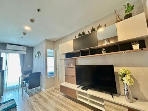 Modern living room with wide-screen TV and decorative shelving