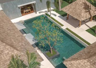 Aerial view of a luxurious backyard with a swimming pool, tree, and gazebo
