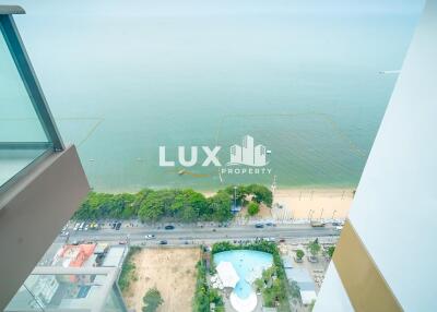 High-rise balcony overlooking the beach and ocean with clear railings