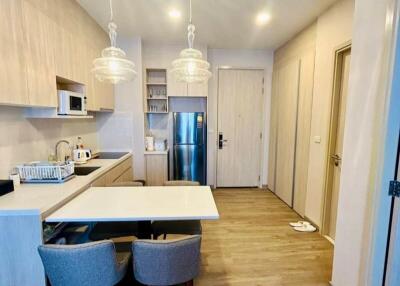 Modern kitchen with dining area and stylish pendant lights