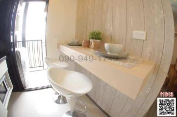 Modern dining area with bar-style seating and natural light