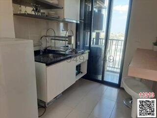 Modern kitchen with natural light and balcony access