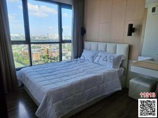 Modern bedroom with large window and city view