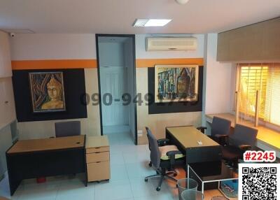 Professional office space with multiple desks and art decor
