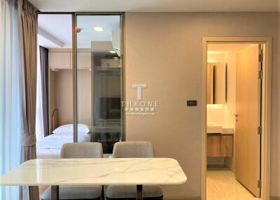 Dining area with a view into the bedroom and a glimpse of the bathroom