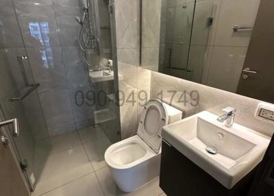 Modern bathroom interior with glass shower and ceramic fixtures