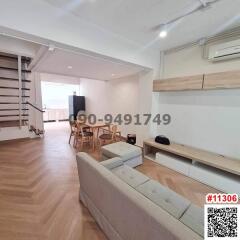 Modern living room with staircase and dining area