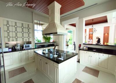 Spacious modern kitchen with white cabinetry and central island