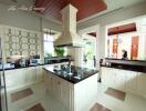 Spacious modern kitchen with white cabinetry and central island