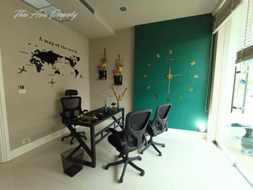 Modern home office with world map wall decor and dual workstations