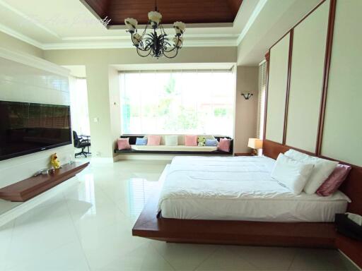 Spacious master bedroom with large windows and modern decor