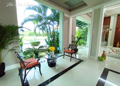 Elegant lobby area with seating and lush garden view