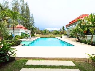 Swimming pool with surrounding garden and mountain view at a residential property