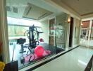 Home gym room with exercise equipment and large windows