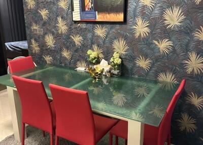 Elegant dining room with red chairs and decorative wallpaper