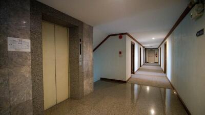 Long corridor inside a residential building with elevator doors