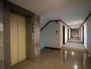 Long corridor inside a residential building with elevator doors