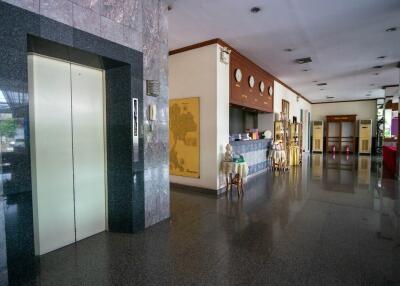 Spacious lobby area with marble flooring and an elevator