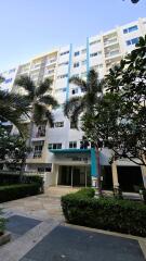 Exterior view of a modern residential building with palm trees