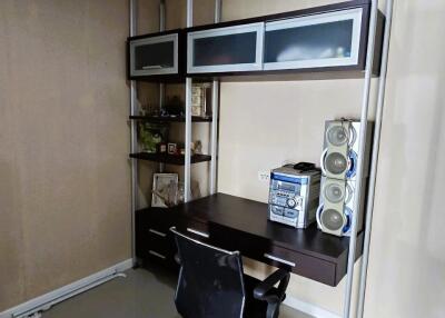 Modern home office with shelving units and rolling chair