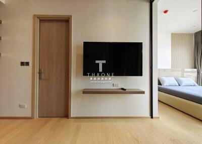 Modern bedroom with a wall-mounted television and minimalist design