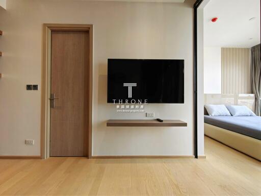 Modern bedroom with a wall-mounted television and minimalist design