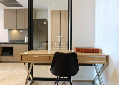 Modern home office with kitchen in the background