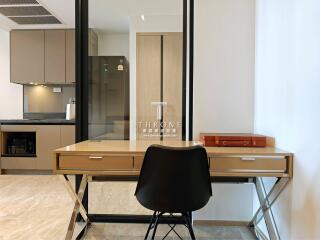 Modern home office with kitchen in the background