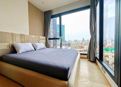 Modern bedroom with city view and large windows