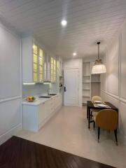 Modern kitchen with white cabinetry and ample shelving