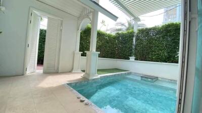 Private pool area with pergola and lush greenery