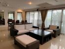 Spacious furnished living room with adjoining dining space