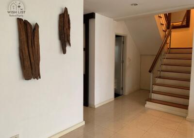 Interior view of a living space with staircase and artistic wall decorations