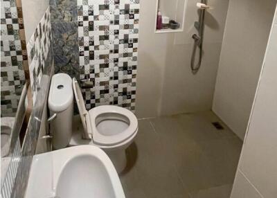 Modern tiled bathroom with shower and bathtub