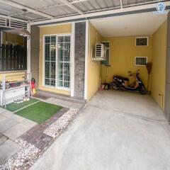 Cozy patio area with motorcycle parking and seating space