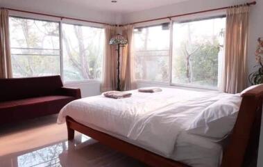 Cozy bedroom with large windows and natural light